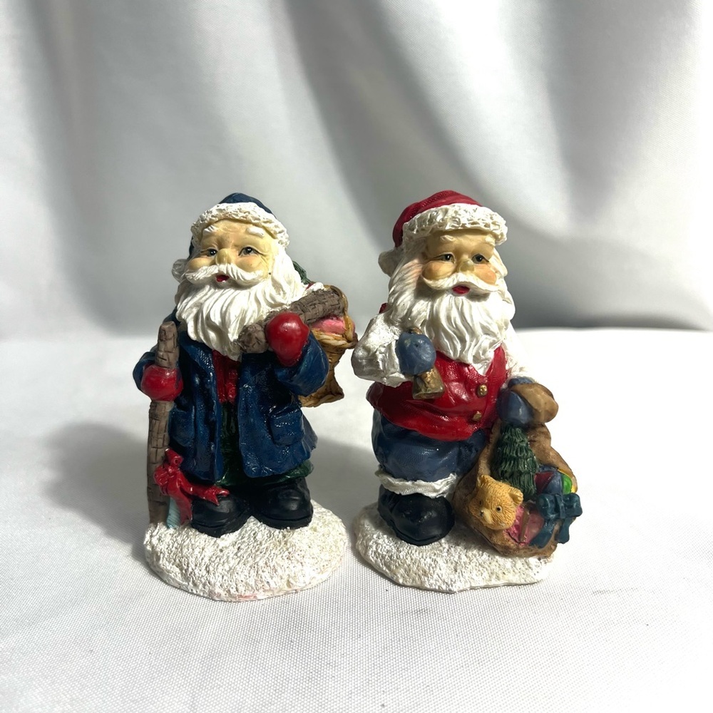 Set Of Two Mini Santa’s In Different Attire Holding Bag Of Toys And Logs Vintage